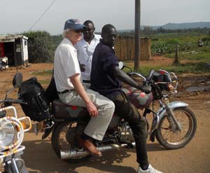 Crossing the Ugandan border on a "boda boda" motorcycle.